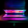 A partially open laptop shows a colorful screen, photo by Ash Edmonds