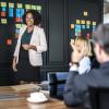 Woman facilitating a Scrum meeting with her agile team