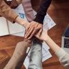 Agile team all putting their hands in for a high five
