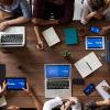 Team working on a project with laptops at a table