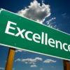 Green sign saying excellence